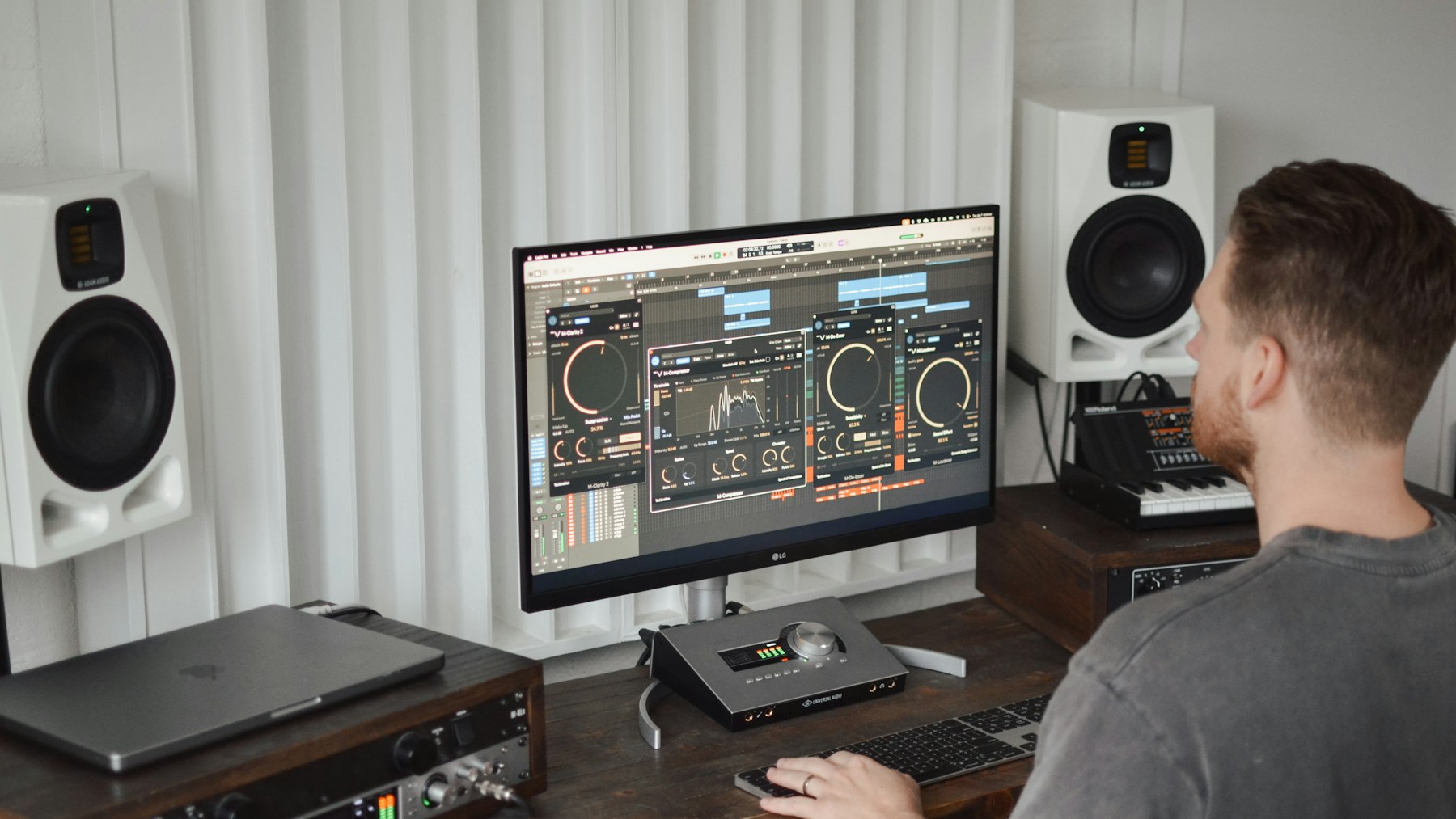 Producer checking audio plug-ins on a studio computer