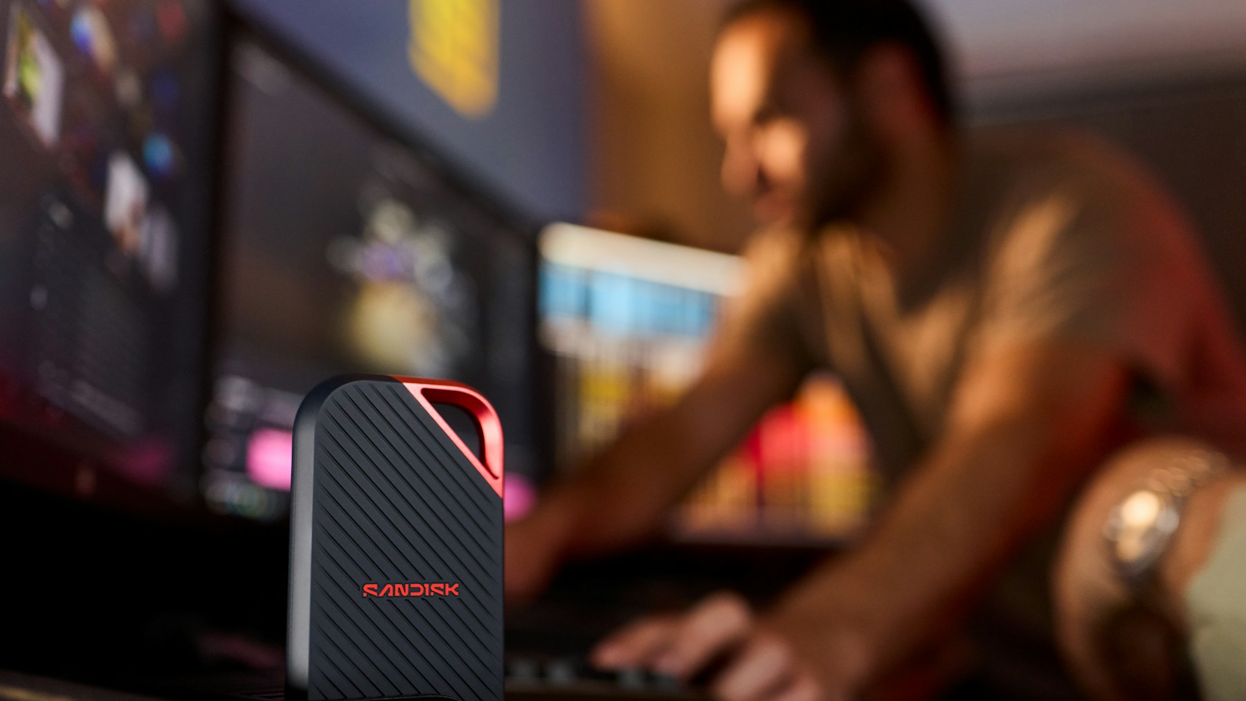 Portable SSD beside a computer used for digital project storage